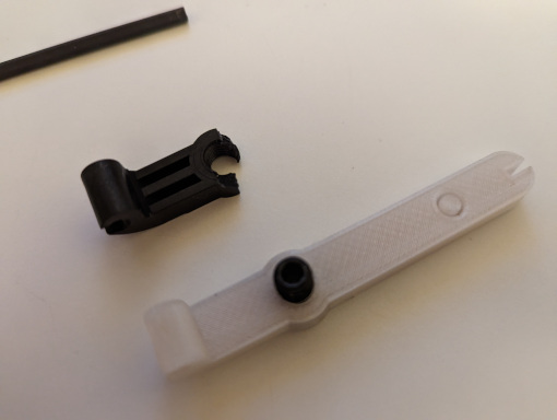 The broken Aeron part next to a printed replacement